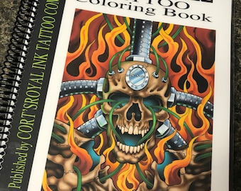 May include: A coloring book titled "Rock N Roll Tattoo Coloring Book" published by "Cort Royal Ink Tattoo Company". The cover features a skull with flames and mechanical parts.
