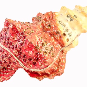May include: A red and white seashell trinket box with gold accents and rhinestones. The box is intricately detailed and has a glossy finish.
