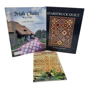 May include: Three quilting books are displayed. The titles are "Irish Chain in a Day", "Starstruck Quilt", and "Hawaiian Quilting Made Easy". The "Irish Chain" book shows a house with a thatched roof and a quilt. The "Starstruck Quilt" book has a quilt pattern on the cover.