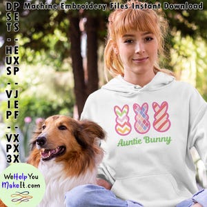 May include: White hoodie with a pink outline of three Easter bunny shapes. The bunnies are decorated with different patterns: chevron, plaid, and stripes. The text "Auntie Bunny" is written in green below the bunnies.