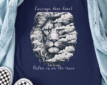May include: A navy blue t-shirt featuring a graphic of a lion's face integrated with clouds, with the text Courage, dear heart and Aslan is on the move. The shirt is layered under a light blue denim button-down shirt with black and white checkered slip-on shoes.