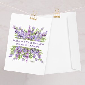 May include: A white card with a purple and green floral design and the quote "There are far better things ahead than any we leave behind." by C.S. Lewis. The card is hanging from a string with gold clips.