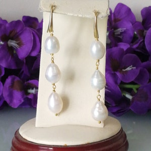 White baroque natural pearl earrings.Three cascading pearl earrings.Silver earrings