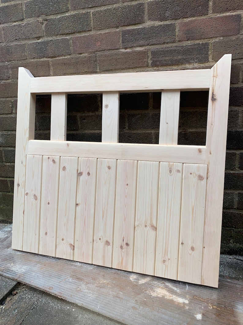 May include: A natural wood gate with a slatted design and a horizontal lattice top. The gate is unfinished and ready to be stained or painted.