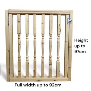 May include: A light-coloured wooden gate with vertical spindles and a rectangular frame. The gate has a metal hinge and latch. The text on the image reads "Height up to 97cm" and "Full width up to 92cm".