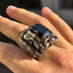 On-hand photo of 925 sterling silver Turkish handmade men’s ring with square black onyx stone and vintage Ottoman engraved setting.