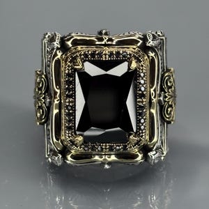Front product shot on gray background showing the square black onyx gemstone centered in a detailed Turkish handmade silver frame.