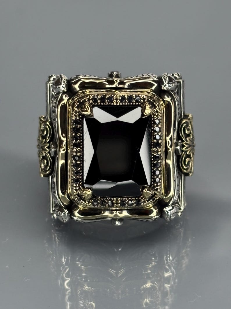 Front product shot on gray background showing the square black onyx gemstone centered in a detailed Turkish handmade silver frame.
