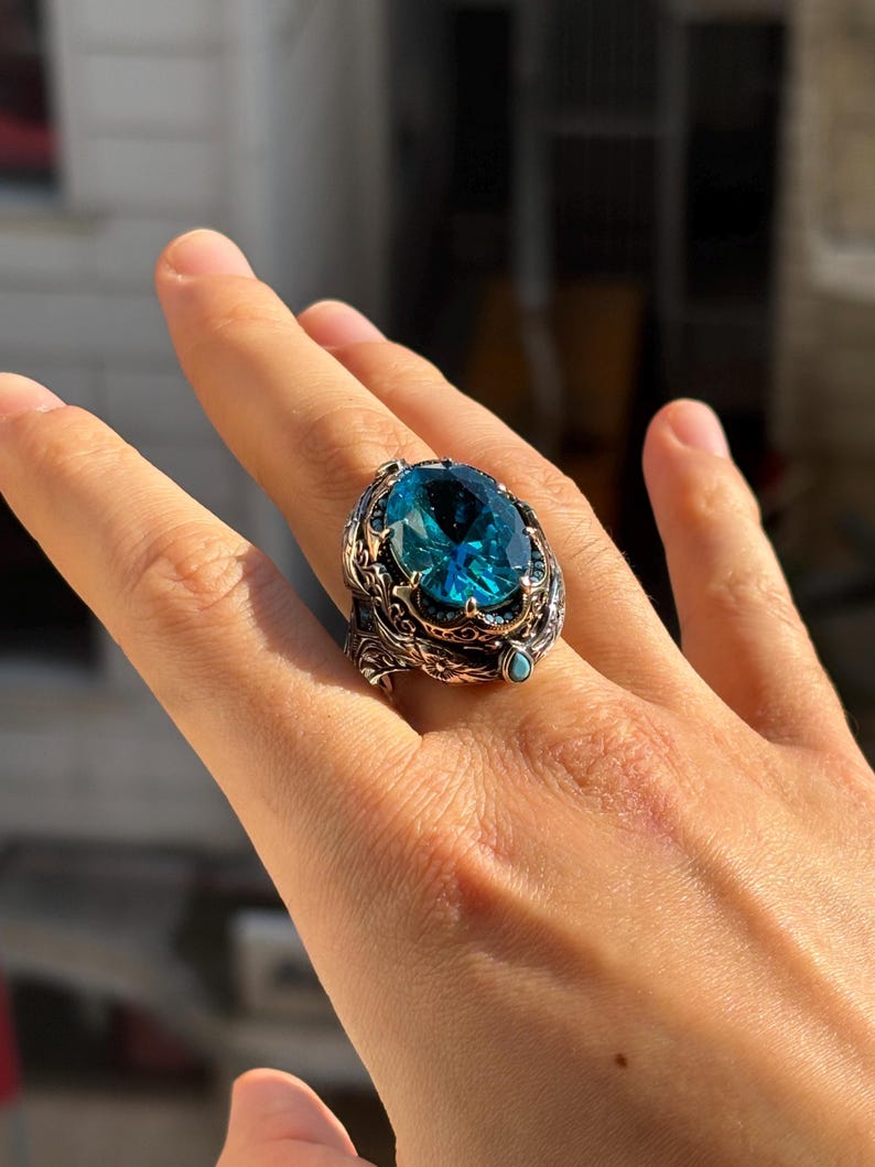 On-hand lifestyle photo showing how the aquamarine blue stone men’s ring looks when worn, with vintage Ottoman details visible.