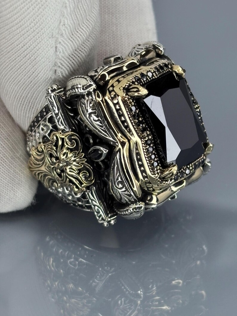 On-hand lifestyle photo showing the black onyx statement ring worn on finger with ornate vintage detailing visible.