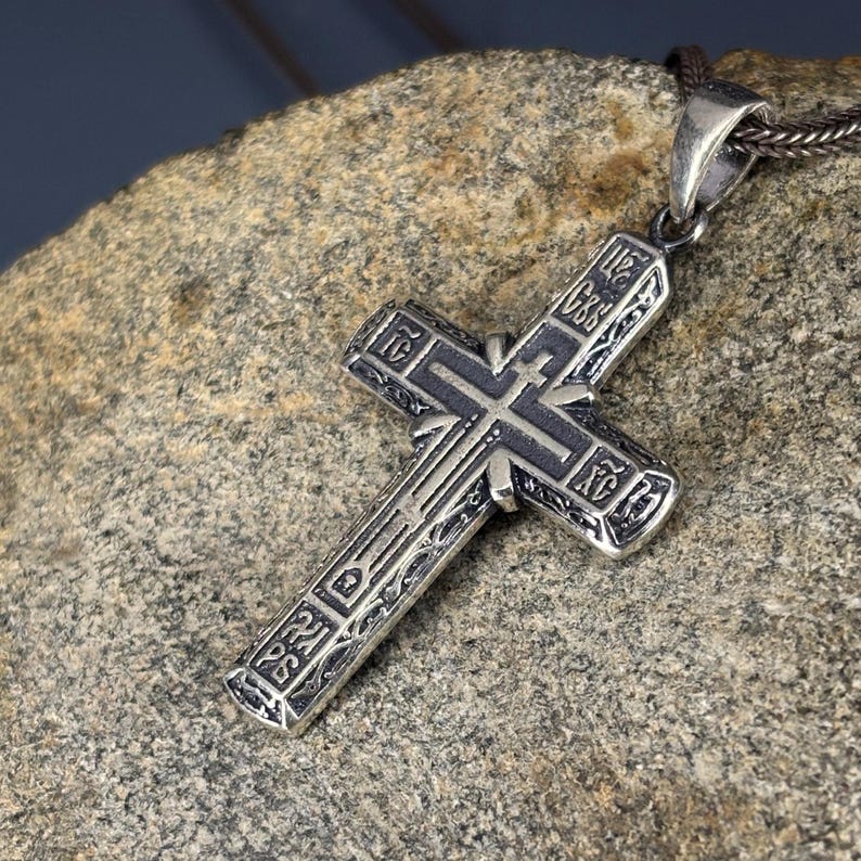 Detailed Orthodox Cross Pendant Necklace, crafted from 925 sterling silver with oxidized engravings. Inspired by Byzantine Christian tradition, this handmade cross is a symbolic piece of faith jewelry, ideal as a baptism gift, Easter necklace, or meaningful present for men who value spiritual strength.