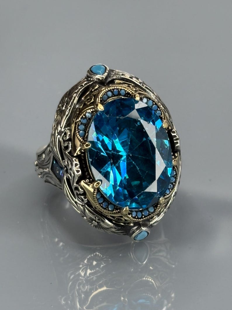 Front product shot on gray background showing the oval aquamarine stone centered in an ornate 925 sterling silver Turkish handmade frame.