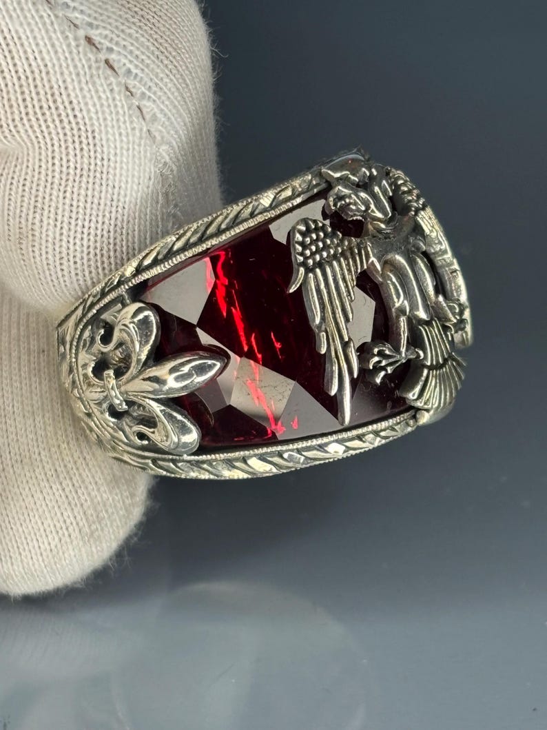 Top-down view of the entire ring showcasing the symmetrical placement of the double-headed eagle motif on each shoulder and the elongated ruby gemstone at the center. The design is clean yet rich in symbolism, embodying tradition and masculine strength.