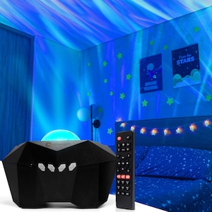 May include: A black star projector with a remote control projects a blue and purple nebula onto a ceiling. The projector has a geometric design and is sitting on a table. The remote control has buttons for different light settings and a timer.