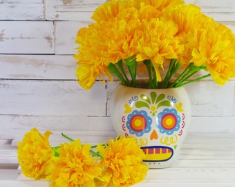 3 cempasúchil flowers with stems made with paper for Day of the Dead altars.