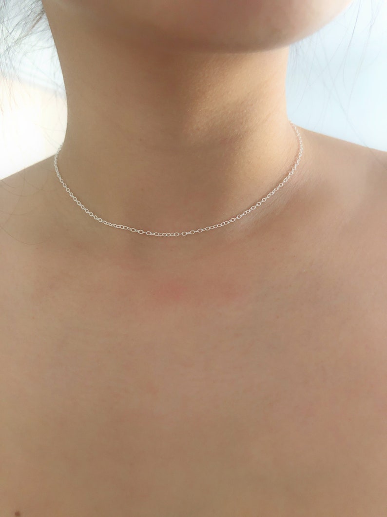 May include: A delicate silver chain necklace, perfect for layering or wearing alone.