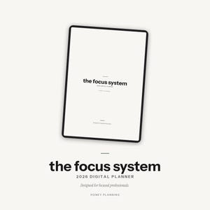 May include: A digital planner titled "the focus system" with the text "2026 Digital Planner" and "Designed for focused professionals." The planner is displayed on a tablet with a black border. The background is a light beige color.