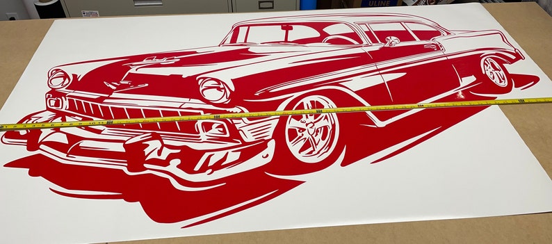 May include: Red and white silhouette of a classic car, possibly a 1950s Chevrolet, on a white background. The car is facing the left side of the image and is partially obscured by a yellow measuring tape.