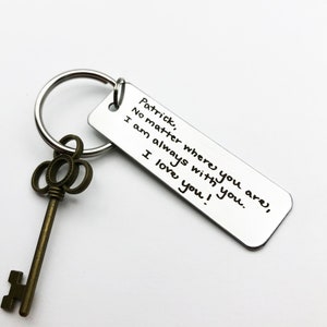 May include: A silver keychain with a key charm and a rectangular tag that reads "Patrick, No matter where you are, I am always with you. I love you!"