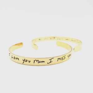 May include: Gold bangle bracelet with the handwritten message "I love you mom I miss you" engraved on the outside.