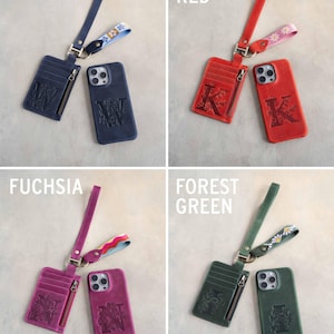 May include: A collage of four leather phone cases and matching cardholders in Blueberry, Poppy Red, Fuchsia, and Forest Green. Each set includes a phone case, cardholder with a zipper, and a wrist strap with decorative floral or patterned accents. The phone cases and cardholders feature embossed initials.