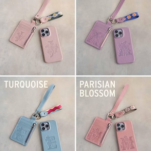 May include: Four leather phone cases and matching cardholders in blush, lilac, turquoise, and Parisian blossom. Each set includes a wrist strap with a decorative floral pattern. The phone cases and cardholders have a floral design.