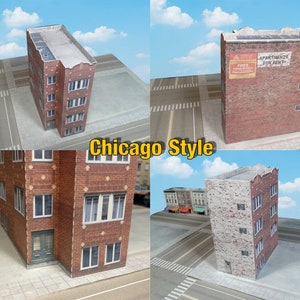 May include: Four model buildings in a Chicago style, with brick facades and multiple windows. The buildings are on a white surface with black lines representing streets.