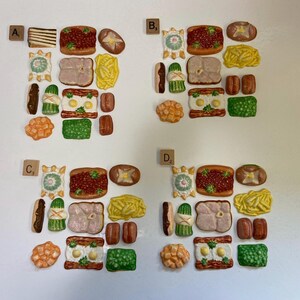 May include: A collection of miniature food items, including toast, sandwiches, eggs, and various other dishes. The items are arranged in a grid-like pattern, with a neutral background. The colors are vibrant, with a focus on the different textures and shapes of the food.