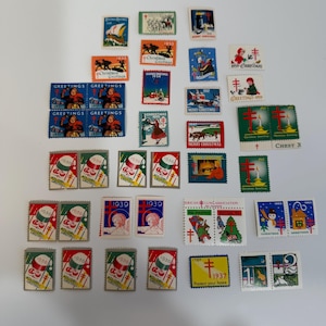May include: A collection of vintage Christmas stamps, featuring various designs and colors. The stamps showcase festive imagery, including angels, snowmen, and holiday greetings. Some stamps display the years 1936, 1939, 1942, 1959, and 1907.