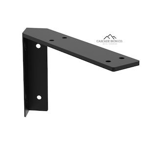 May include: A black metal shelf bracket with a right-angle design. The bracket has pre-drilled holes for mounting and features the text "CASCADE IRON CO." in white. This sturdy bracket is suitable for various shelving applications.