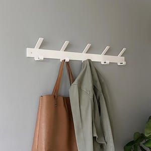 May include: A distressed wooden sign, inscribed with "Welcome to our home" in white. The sign has a rustic finish, ideal for a porch or hallway, creating a welcoming atmosphere.