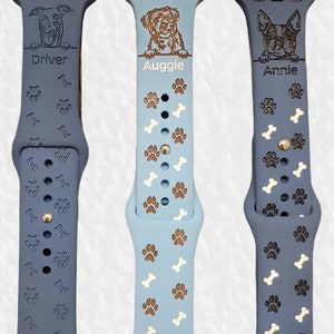 May include: Three blue and white patterned Apple Watch bands with personalized dog portraits and names: Driver, Auggie, and Annie.
