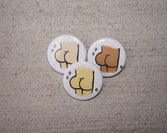 May include: Three round white buttons with black outlines. Each button features a cartoon illustration of a rear view of a person with different skin tones. The buttons are arranged in a triangular shape.