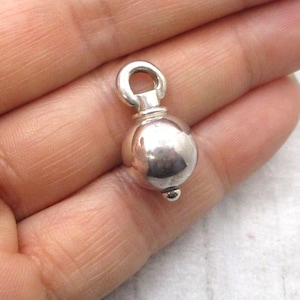Sphere urn for ashes in sterling silver. Used for holding cremated remains of people, dogs, cats, horses and pets. Made by hand in Canada.