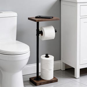 May include: A freestanding toilet paper holder featuring a dark wood base and top shelf, connected by a vertical black metal pipe. The unit includes a horizontal arm for one roll of toilet paper and space on the base for two additional rolls.