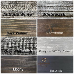 May include: A grid of eight wood finish samples labeled Antique White, Whitewash, Dark Walnut, Espresso, Gray Whitewash, Gray on White Base, Ebony, and Black. Each square displays a distinct wood grain texture, color, and stain application style.