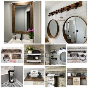 May include: A collection of rustic bathroom fixtures, including a framed mirror, towel racks, and a toilet paper holder. The fixtures are made of wood and metal, with a dark brown finish. The towel racks and toilet paper holder have a pipe-like design.