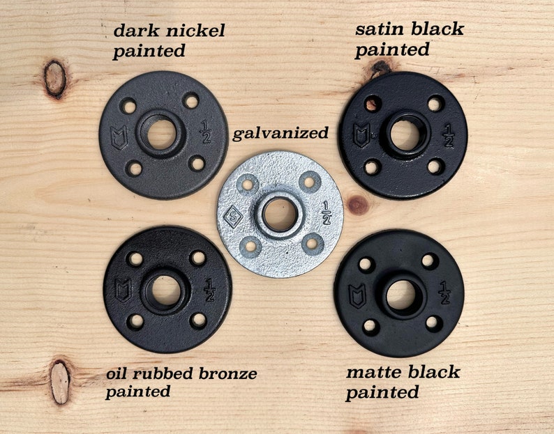 May include: Five circular metal floor flanges with four screw holes and a central threaded opening marked 1/2 inch. The finishes include dark nickel, satin black, galvanized silver, oil rubbed bronze, and matte black paint, each labeled accordingly.