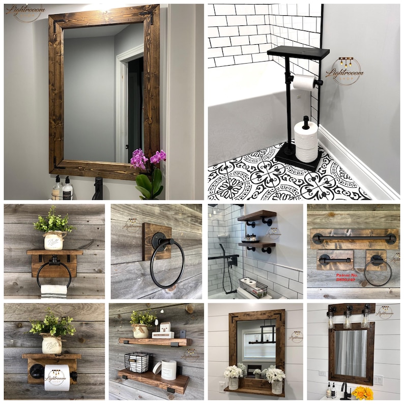 May include: A collection of rustic bathroom decor items. Includes a large wooden framed mirror, a black toilet paper stand, wooden shelves, towel racks, and a mirror with a light fixture. The items have a natural wood finish and black metal accents.
