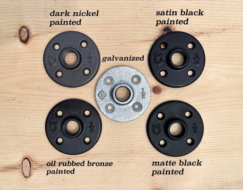 May include: Five circular metal floor flanges with four mounting holes and a central threaded opening marked 1/2 inch. Finishes include dark nickel painted, satin black painted, galvanized, oil rubbed bronze painted, and matte black painted.