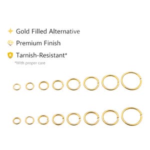 May include: Two rows of eight gold-colored circular rings in graduated sizes. Text reads: Gold Filled Alternative, Premium Finish, Tarnish-Resistant* *With proper care. The rings are thin, metallic, and feature a small opening on one side.