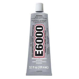 May include: A tube of E6000 industrial strength adhesive. The tube is silver with a white cap. The text "E6000" is printed in large, bold, black letters. The tube contains 3.7 fl oz (109.4 mL) of adhesive.