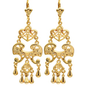 May include: Gold dangle earrings with a filigree design and multiple tiers of small beads.