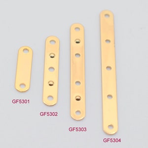 May include: Four gold-colored metal connector bars of varying lengths. Each bar has a series of evenly spaced holes for attaching to other components. The shortest bar is labeled GF5301, and the longest is GF5304.