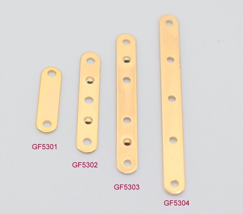 May include: Four gold-colored metal connector bars of varying lengths. Each bar has a series of evenly spaced holes for attaching to other components. The shortest bar is labeled GF5301, and the longest is GF5304.