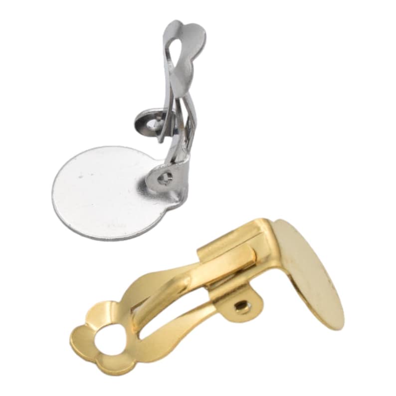 May include: Two earring clips, one silver and one gold. The silver clip has a round back, while the gold clip has a more oval-shaped back.