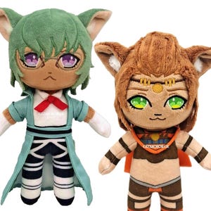 May include: Two plush toys, one green with purple eyes and a blue and white outfit, the other brown with green eyes and an orange and brown outfit.