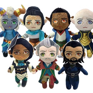 May include: Seven plush dolls with embroidered faces and diverse outfits. The dolls feature different skin tones, hair colours, and accessories like horns, hats, and scarves. The dolls are designed with a cartoonish aesthetic, and are made of soft fabric.