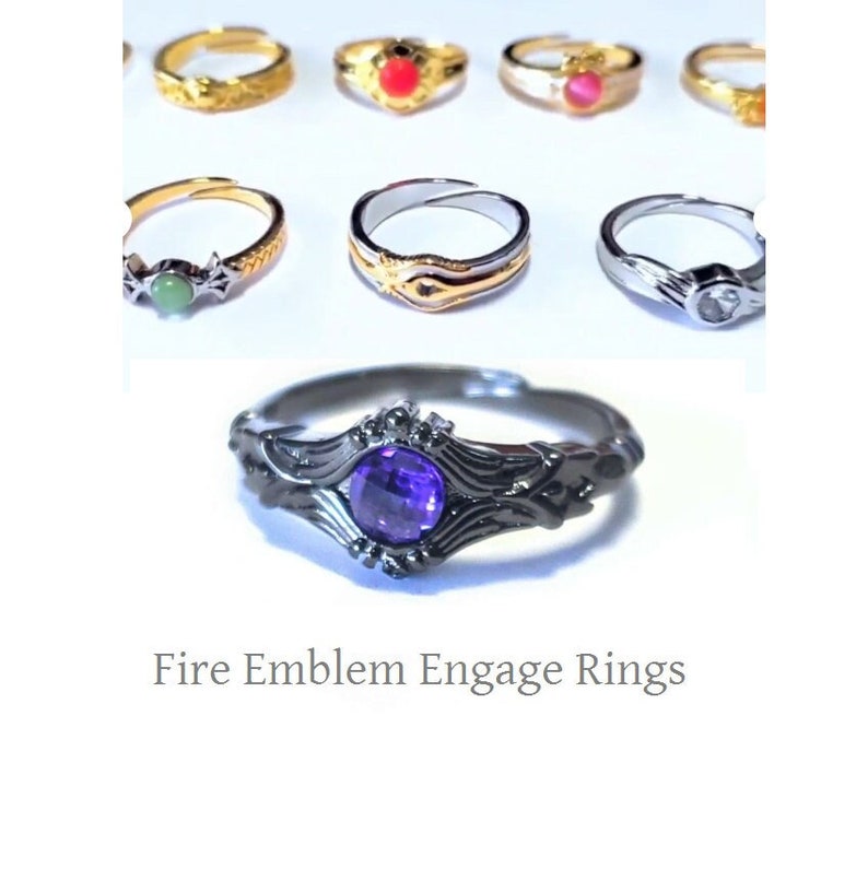 May include: A collection of rings with various designs and gemstones. The rings are gold, silver, and black, with gemstones in red, pink, green, and purple. The text "Fire Emblem Engage Rings" is at the bottom.