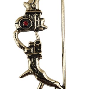 May include: A gold-colored bow and arrow keychain. The bow features intricate detailing and a red gem in the center. The arrow is a simple, straight design. The keychain is suspended from a small chain.